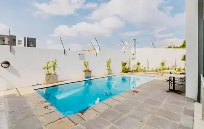 a swimming pool in the middle of a patio at Cozy Carlswald EXcape in Midrand