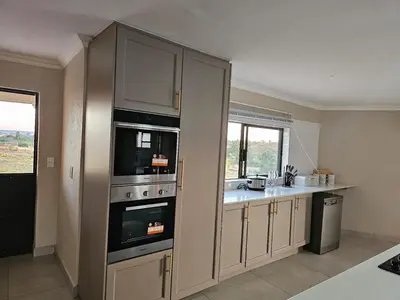 a kitchen with two ovens and a counter top at Outerspaces Farmhouse Retreat