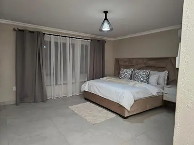 a bedroom with a bed and a large window at Outerspaces Farmhouse Retreat