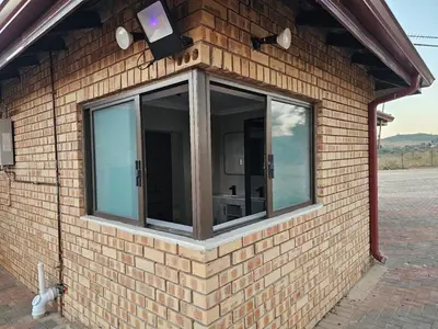 a window on the side of a brick building at Outerspaces Farmhouse Retreat