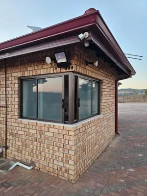 a brick building with a window on it at Outerspaces Farmhouse Retreat