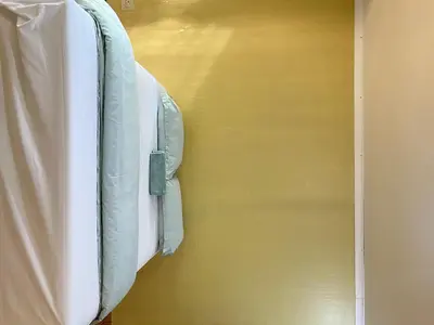 a bed is hanging on a wall at Bugera's Palace in Pretoria