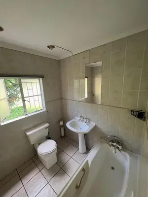 a bathroom with a toilet and a sink and a tub at Bugera's Palace in Pretoria
