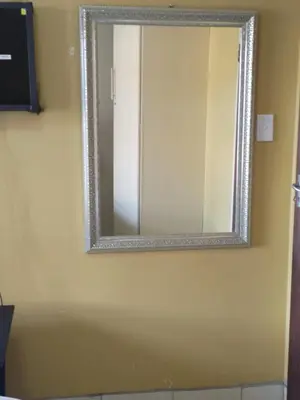 a mirror on a wall in a room at Queen Guest House in Pretoria