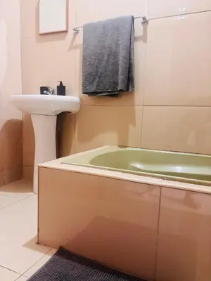 a bathroom with a sink and a bath tub next to a sink at 54 River Logde in Mokopane