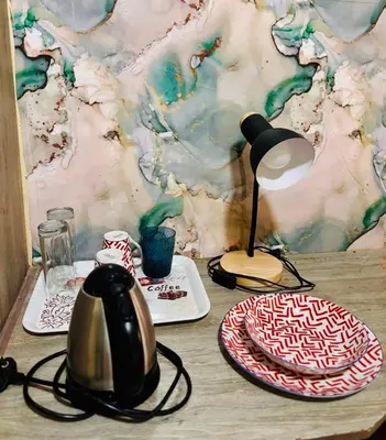 a table with a tea kettle and plates on it at 54 River Logde in Mokopane