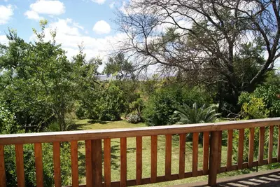 a wooden fence with a view of a garden at Mukurumanzi Lodge in Polokwane