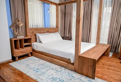 a bedroom with a bed with a wooden frame at CasaRegalo180 in Pretoria