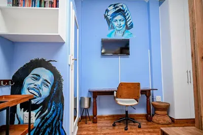 a room with a painting on the wall and a desk at CasaRegalo180 in Pretoria