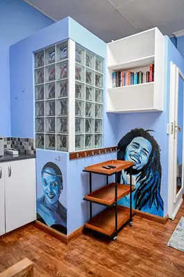a kitchen with a painting on the wall at CasaRegalo180 in Pretoria