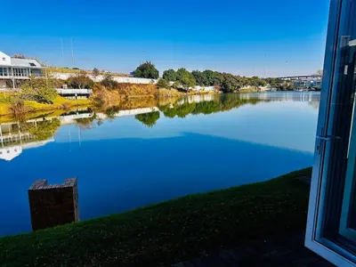 a view of a river from a window at BKM Retreat Lake View in Pretoria