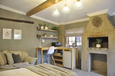 a living room with a bed and a fireplace at StayFit 06 in Polokwane