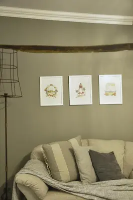 a living room with a couch and four pictures on the wall at StayFit 06 in Polokwane