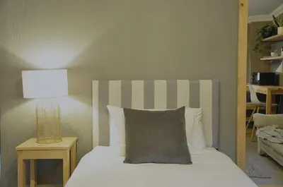a bed with a pillow and a lamp on a table at StayFit 06 in Polokwane