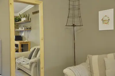 a living room with a mirror and a couch at StayFit 06 in Polokwane