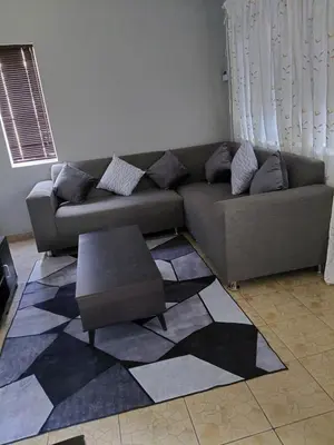 a living room with a couch and a coffee table at Shalom self catering Cottage in Centurion