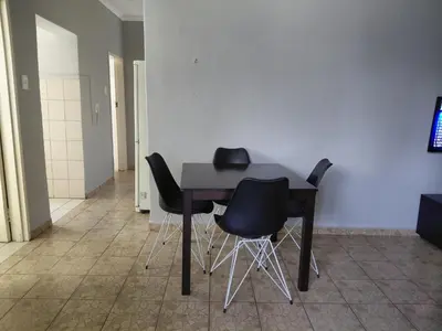 a black table with black chairs in a room at Shalom self catering Cottage in Centurion