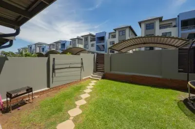 a yard with a fence and a bench and some buildings at 231 Whisken Ave, Crowthorne Ah in Midrand