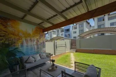 a patio with a mural on the side of a building at 231 Whisken Ave, Crowthorne Ah in Midrand