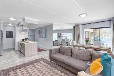 a large living room with a couch and a kitchen at 231 Whisken Ave, Crowthorne Ah in Midrand