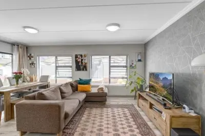 a living room with a couch and a tv at 231 Whisken Ave, Crowthorne Ah in Midrand