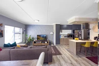 a living room with a couch and a kitchen at 231 Whisken Ave, Crowthorne Ah in Midrand