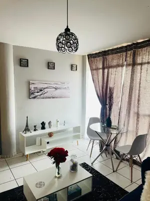 a white living room with a table and chairs at Cloud 10 Hideaway in Pretoria