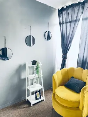 a living room with a yellow couch and a window at Cloud 10 Hideaway in Pretoria