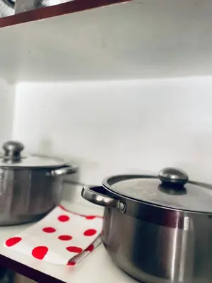 two pots on a stove with a towel with hearts at Cloud 10 Hideaway in Pretoria