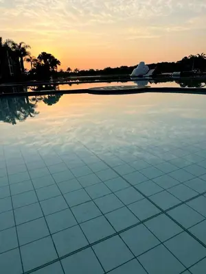 a large swimming pool with blue tiles on top of it at The Blyde Crystal lagoon 3-bed entire apartment in Pretoria