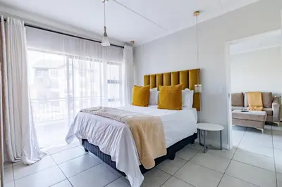 a bedroom with a large bed with yellow pillows at Crystal Lagoon lifestyle holiday in Pretoria
