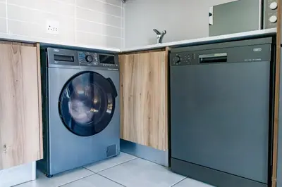 a washing machine in a kitchen with a sink at Crystal Lagoon lifestyle holiday in Pretoria