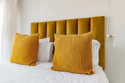 a bed with two yellow pillows on it at Crystal Lagoon lifestyle holiday in Pretoria