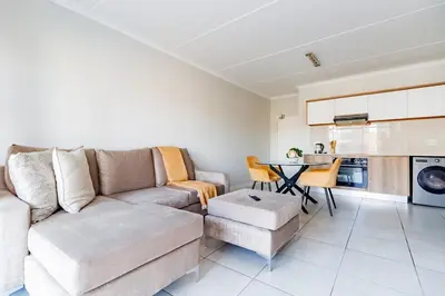 a living room with a couch and a table at Crystal Lagoon lifestyle holiday in Pretoria