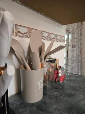 a bucket full of utensils sitting on a counter at The Garden on Hartbeespoort in Hartbeespoort