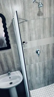 a bathroom with a sink and a shower at De Mose Family Lodge in KwaZibukwane
