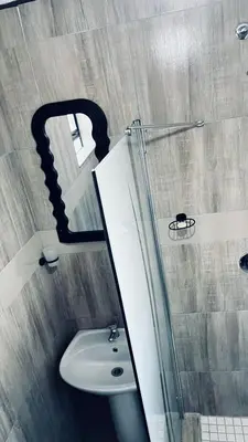 a bathroom with a sink and a mirror at De Mose Family Lodge in KwaZibukwane
