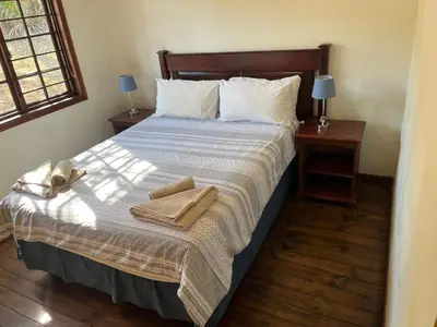 a bedroom with a bed with two towels on it at 7 on Bellevue in White River