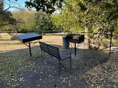 two picnic tables and a bench in a park at 7 on Bellevue in White River
