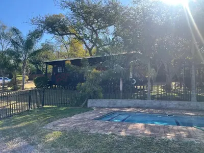 a house with a fence and a swimming pool at 7 on Bellevue in White River