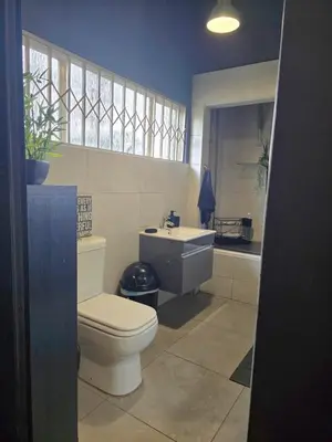 a bathroom with a toilet and a sink at Sunset View in Pretoria