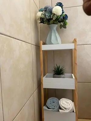 a vase with a plant on a shelf in a bathroom at Wampi guesthouse in Polokwane