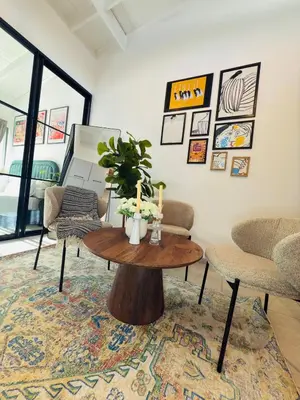 a living room with a table and two chairs at Menlyn Luxe Stay 1BR, Free Parking in Pretoria