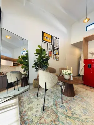 a living room with a table and a chair at Menlyn Luxe Stay 1BR, Free Parking in Pretoria