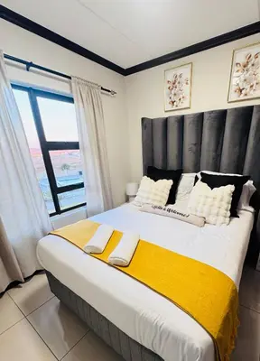 a large bed in a room with a large window at Luxury Lakeview Stay With Workspace in Midrand