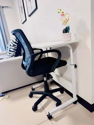 a desk with a chair next to a bed at Luxury Lakeview Stay With Workspace in Midrand