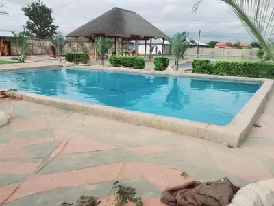 a swimming pool in a resort with a gazebo at Mulwela Palace & Resort in Sigande