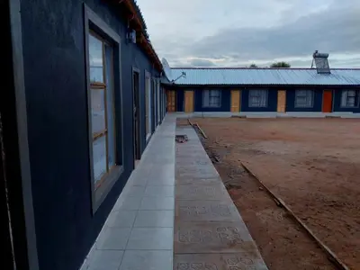 an empty hallway of a building next to a field at Mulwela Palace & Resort in Sigande