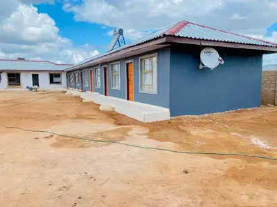 a blue building with a hose in front of it at Mulwela Palace & Resort in Sigande