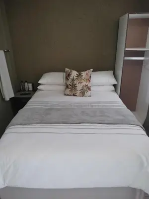 a large white bed with two pillows on it at Mantsho Lagoon